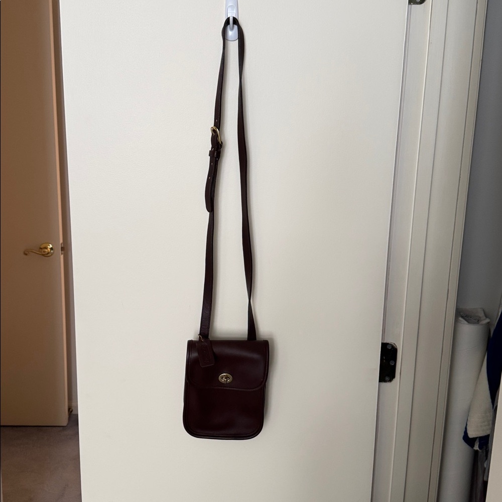 Coach vintage small brown leather crossbody bag with long adjustable strap.